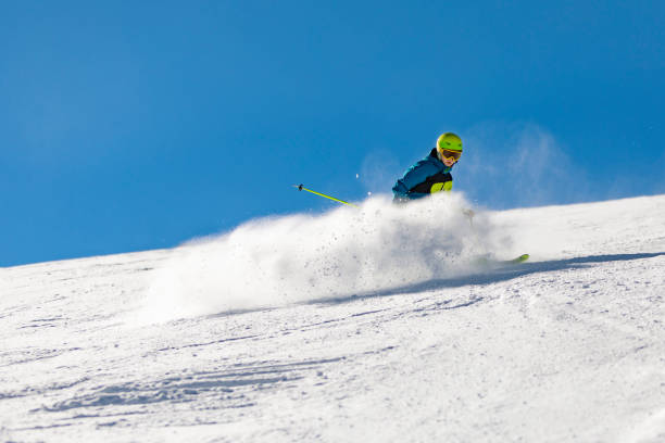 istock School age boy skiing in mountains at ski resort 1443495781