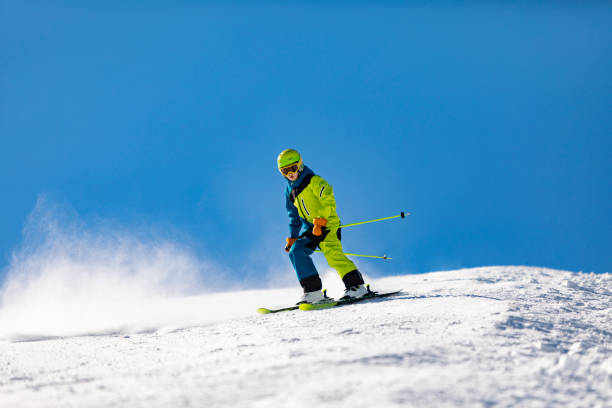 istock School age boy skiing in mountains at ski resort 1443495798