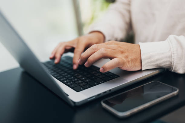 istock closeup of hands typing on a notebook, keyboard 1443496415