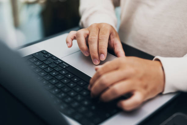 istock closeup of hands typing on a notebook, keyboard 1443496476