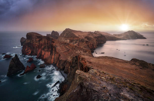 Nice ocean landscape - Dramatic sunrise over colorful cliffs of Ponta de Sao Lourenco in Madeira Island, Portugal. stock photo