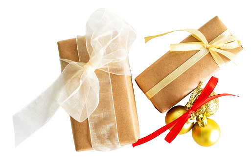 Two wrapped in rustic paper gift boxes with christmas baubles on white or transparent background.