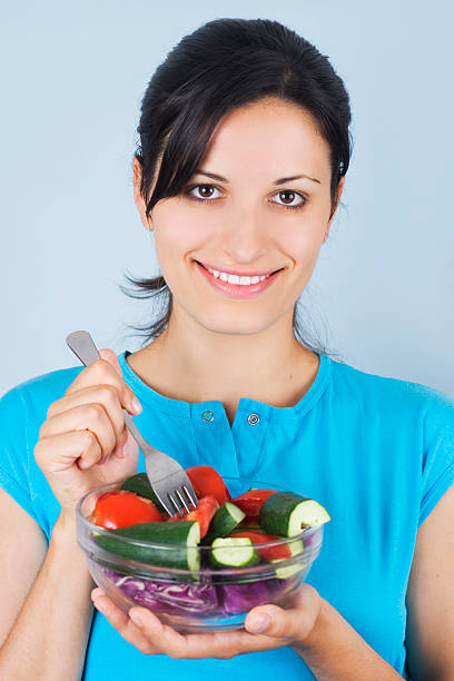 istock girl holding plate with salad 144349773