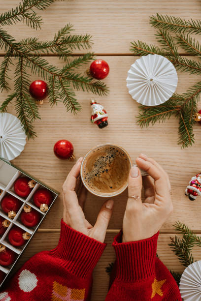 istock christmas gift wrapping drinking coffee hands from above flat lay 1443497811