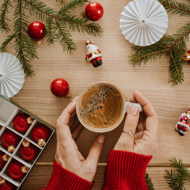 istock christmas gift wrapping drinking coffee hands from above flat lay 1443497981