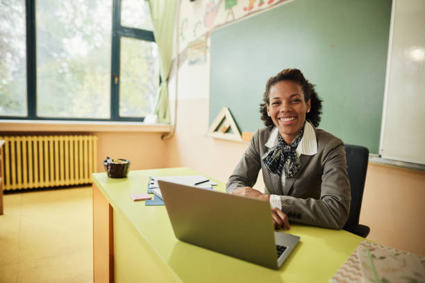 istock Happy black female teacher working in the classroom. 1443498397