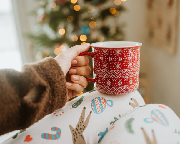 Drinking christmas coffee infront of ornate christmas tree\nPhoto taken from personal perspective