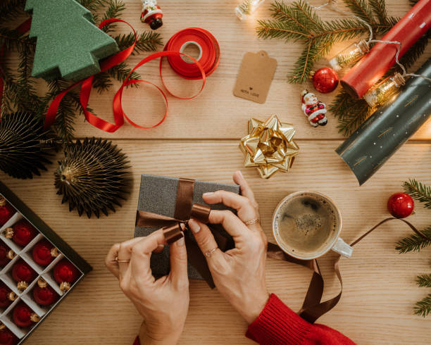 istock christmas gift wrapping and hands from above flat lay 1443498456