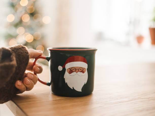 Drinking christmas coffee infront of ornate christmas treePhoto taken from personal perspective