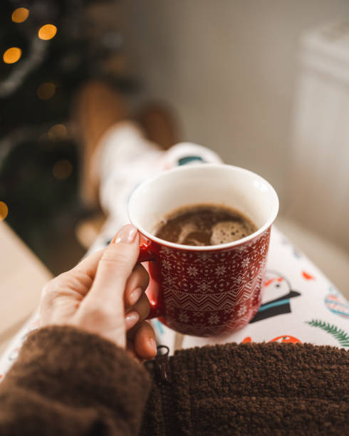 istock Drinking christmas coffee infront of ornate christmas tree 1443499296