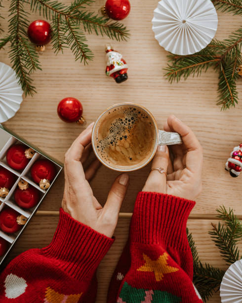 istock christmas gift wrapping drinking coffee hands from above flat lay 1443499372