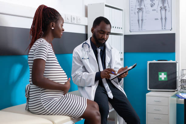 istock Woman expecting child and doing examination with medic 1443501491