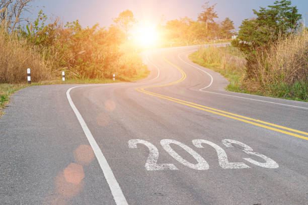 New year 2023 forward concept. Word 2023 written on the asphalt road at sunset sky. Concept of planning, challenge and goal. stock photo