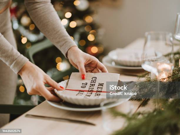 Woman Setting The Christmas Table Preparing For Dinner Party Stock Photo - Download Image Now