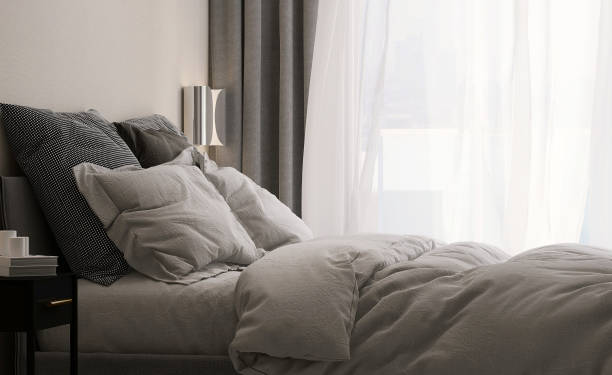 Modern and luxury design bedroom with dark gray bed, bedside table in sunlight from window sheer and blackout curtain