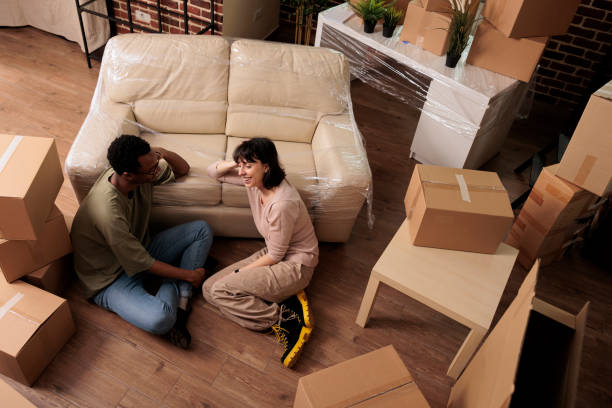 istock Diverse married couple sitting on apartment floor and enjoying relocation 1443503499