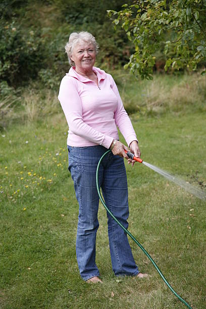 istock Granmother watering the garden 144350409