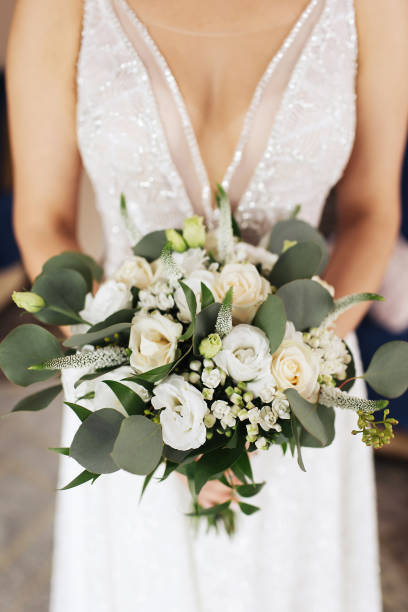 istock Wedding bouquet. Bride in veil holding boho style bouquet. Rustic wedding flowers. Preparation for ceremony. 1443504347