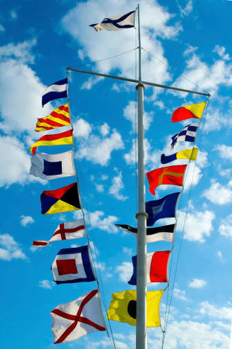 international maritime signal flags against a blue sky