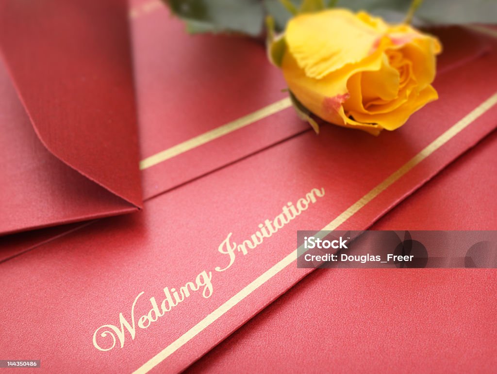 A red wedding invitation with yellow flowers Wedding Invitation with rose. Shallow focus on front word. Wedding Invitation Stock Photo