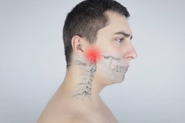 Schematic representation of pain in the jaw. Augmented reality. An x-ray of the jaw bone superimposed on a photograph. Painful areas are highlighted in red. Human bone disease. Osteomyelitis Schematic representation of pain in the jaw. Augmented reality. An x-ray of the jaw bone superimposed on a photograph. Painful areas are highlighted in red. Human bone disease. Osteomyelitis. salivary gland surgery stock pictures, royalty-free photos & images