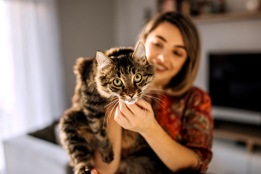 Shot of a beautiful young woman enjoying a cuddle with her cat