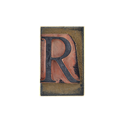 High quality photograph of an old stamp with a capital letter with serifs. Nice retro crunch style in flat lay on white background. Check out more letters: