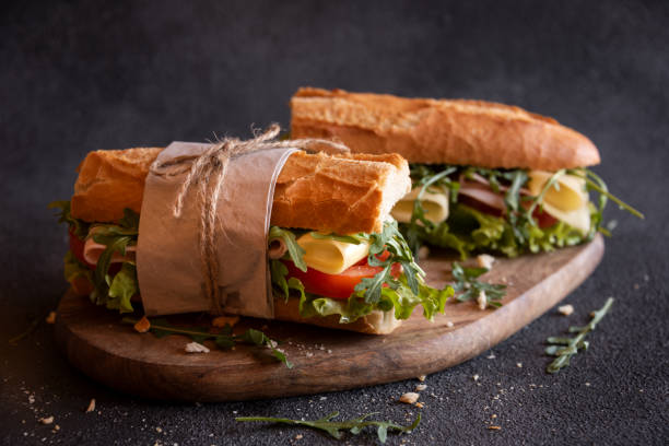 istock Baguette sandwich with cheese, ham, tomatoes and vegetables 1443509334