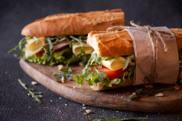istock Baguette sandwich with cheese, ham, tomatoes and vegetables 1443509459