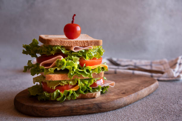 istock Homemade sandwich with cheese, ham, tomatoes and vegetables 1443511153
