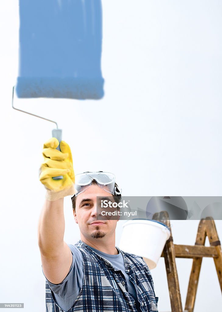 Home improvement Manual worker painting the wall. 30-39 Years Stock Photo