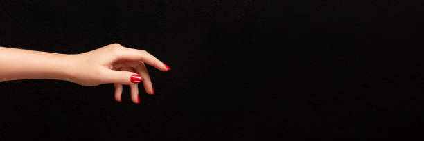 istock Female hand with red nails banner 1443512588