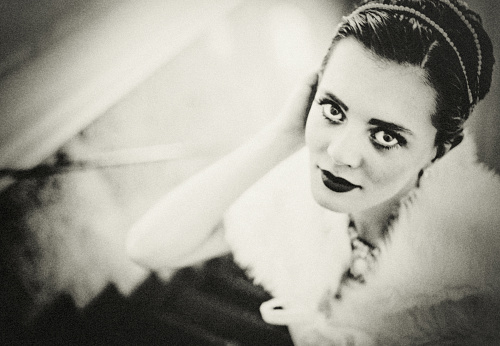 Black and white retro female portrait in the style of 20s or 30s. Photo in vintage style.