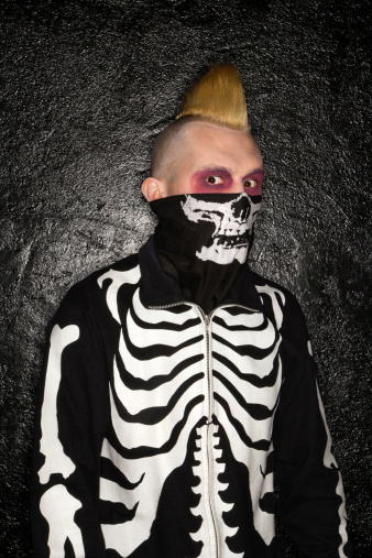 Mid-adult Caucasian male punk wearing skeleton costume.