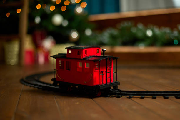 istock Vintage train car is on the floor under a Christmas tree 1443515801