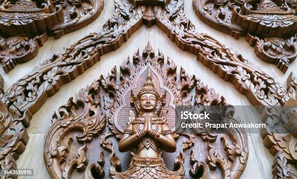 Low Angle View Of Wood Carving Deva Clasping Hand Pattern On Teak Wooden Wall Of Wat Krok Krak Temple At Samut Sakhon Thailand Stock Photo - Download Image Now