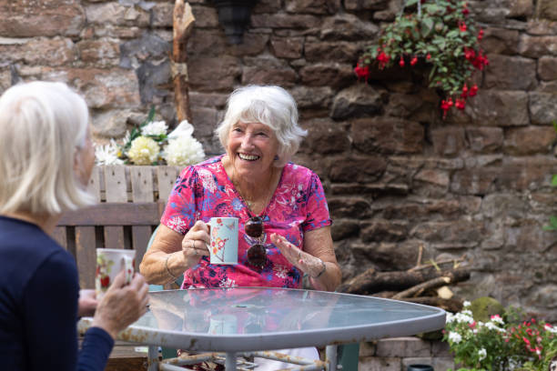 Two Senior Friends Relaxing in Garden