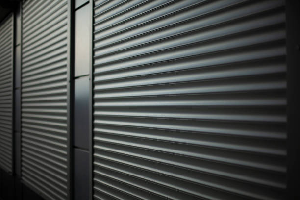 istock Blinds on windows of store. Steel blinds for large windows. Ribbed surface against wall. 1443517735