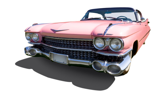 A pink American automobile, the icon of 1950's elegance, is isolated against a white background with shadow and includes clipping path. 