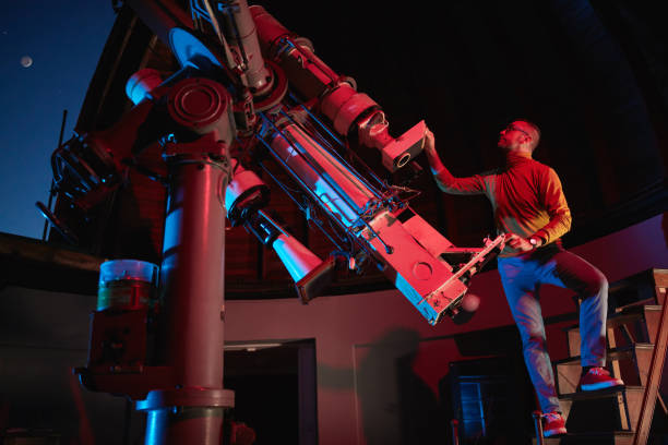 istock Astronomer with a big astronomical telescope in observatory doing science research of space and celestial objects. 1443520730