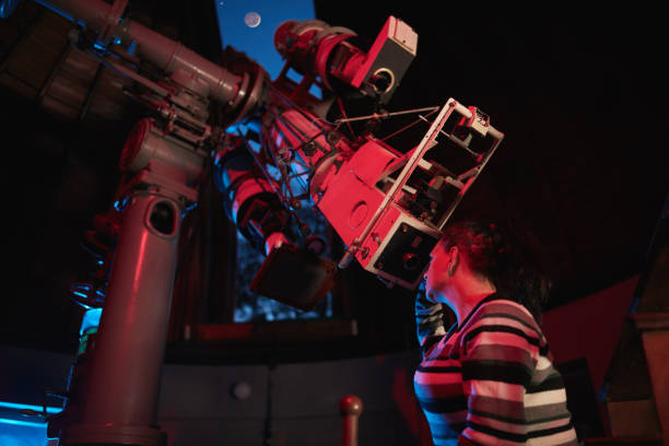 istock Astronomer with a big astronomical telescope in observatory doing science research of space and celestial objects. 1443520754