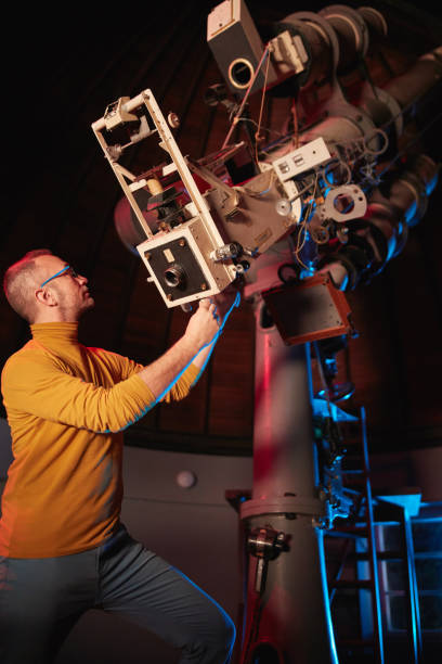 istock Astronomer with a big astronomical telescope in observatory doing science research of space and celestial objects. 1443520796