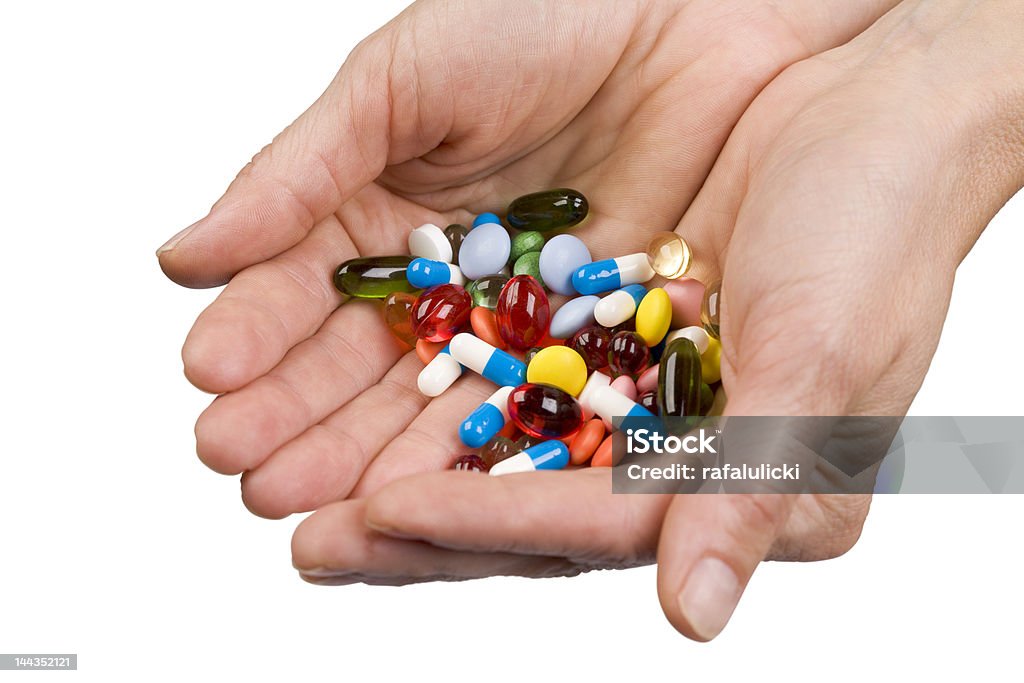 Hand with pills Giving pills to patient. Photo with clipping path. Order Stock Photo