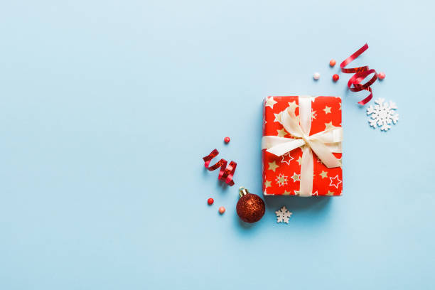 istock Top view Flat lay Christmas decorations and gift box on colored background with copy space. Christmas or Happy New Year composition 1443521565