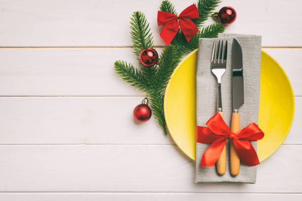 istock Christmas table place setting with christmas decor and plates, kine, fork and spoon. Christmas holiday background. Top view with copy space 1443521645