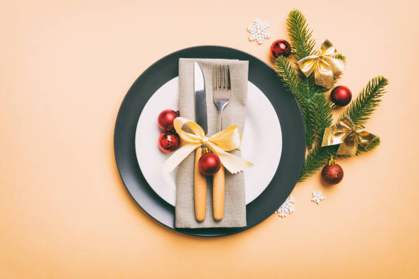 istock Christmas table place setting with christmas decor and plates, kine, fork and spoon. Christmas holiday background. Top view 1443521685