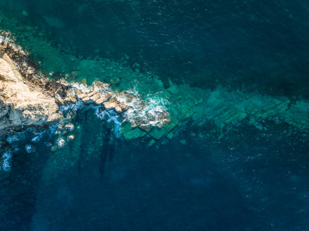 istock Rocky Island Jutting into the Ocean at Sunset 1443523495