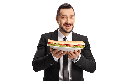 Businessman holding a sandwich on a plate isolated on white background