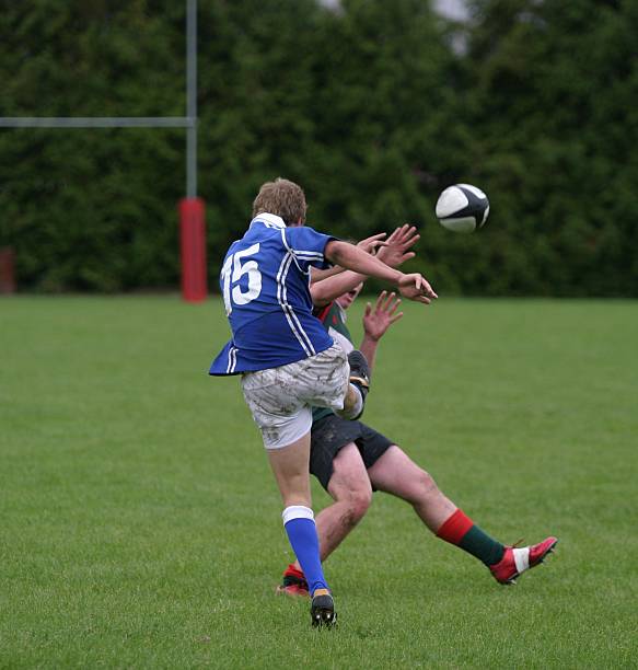 Rugby Charge down. Fullback on a New Zealand club rugby team has his kick charged down by an opposition team member. rugby team stock pictures, royalty-free photos & images