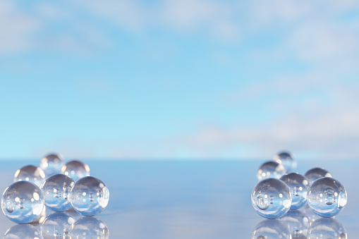 Abstract creative background for product placement. Empty blank space and glass balls on mirror surface against white wall. Image for presenting products. 3d rendering
